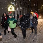 Boys chase each other in the snow