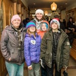 Family of 5 in winter gear prepare to leave the event