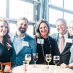 Five adults at wine table